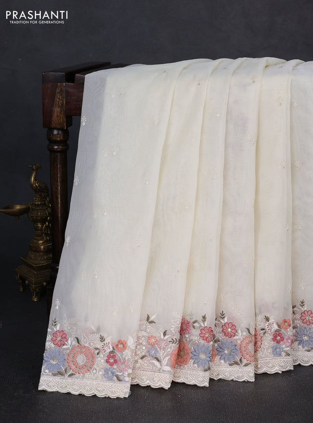 Organza saree cream with embroidery buttas and embroidery border