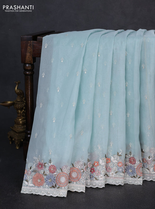 Organza saree light blue with embroidery buttas and embroidery border