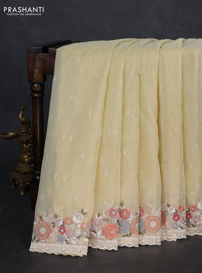 Organza saree pale yellow with embroidery buttas and embroidery border