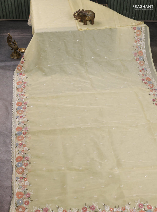 Organza saree pale yellow with embroidery buttas and embroidery border