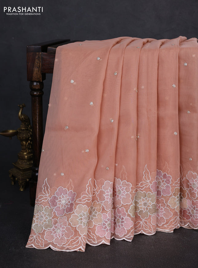 Organza saree peach shade with sequin embroidery buttas and floral embroidery border