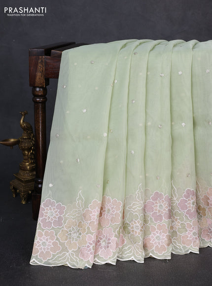 Organza saree pista green with sequin embroidery buttas and floral embroidery border