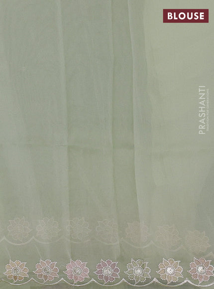 Organza saree pista green with sequin embroidery buttas and floral embroidery border
