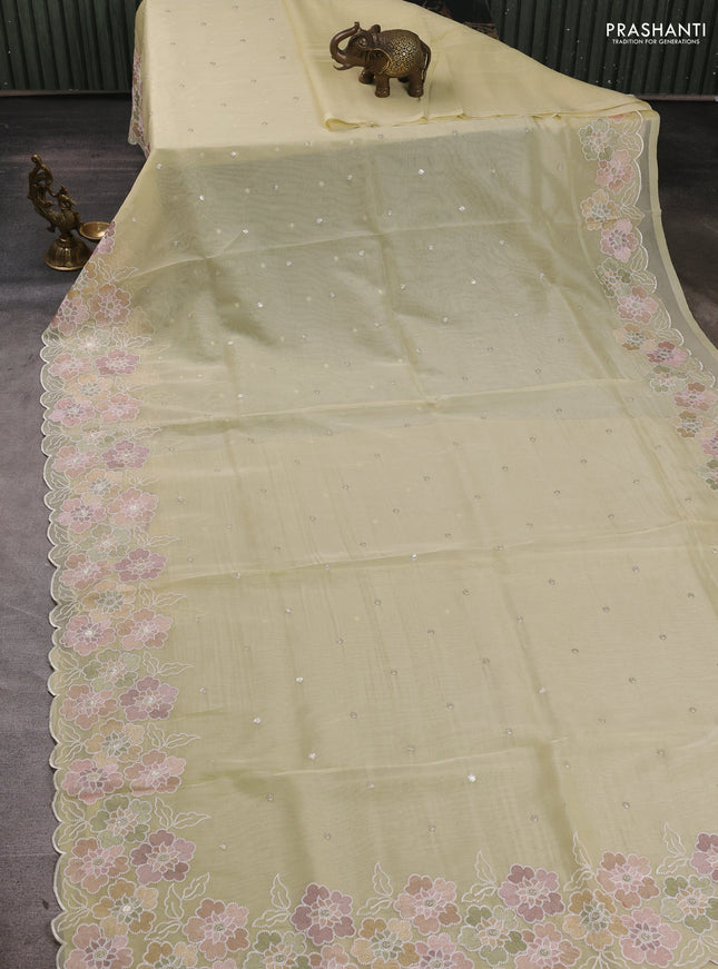Organza saree pale yellow with sequin embroidery buttas and floral embroidery border