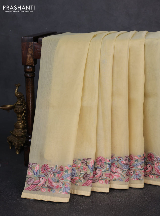 Organza saree pale yellow with plain body and convent embroidery border