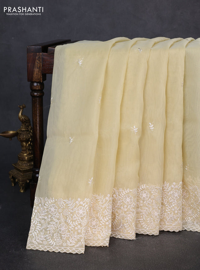 Organza saree pale yellow with embroidery buttas and embroidery border