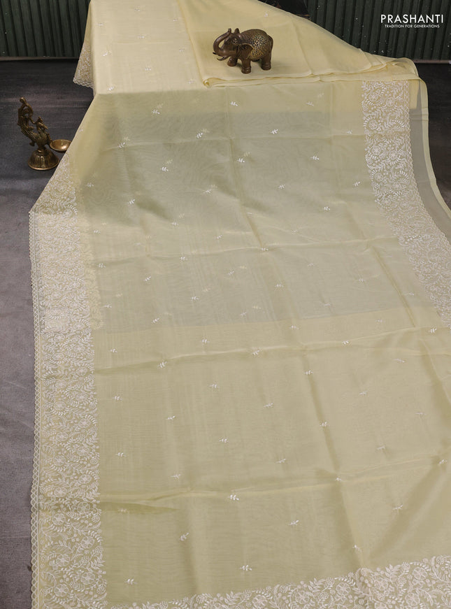 Organza saree pale yellow with embroidery buttas and embroidery border