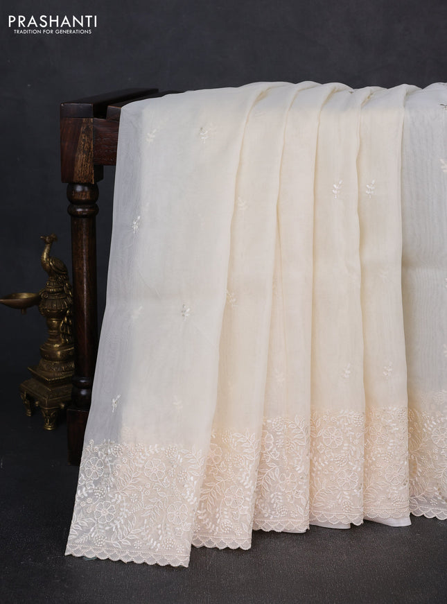 Organza saree cream with embroidery buttas and embroidery border