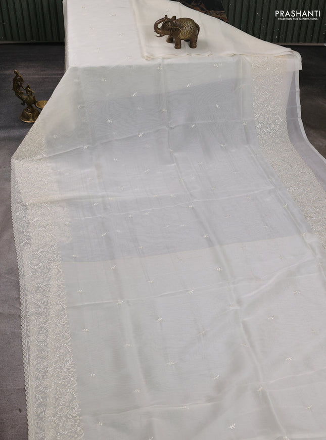 Organza saree cream with embroidery buttas and embroidery border