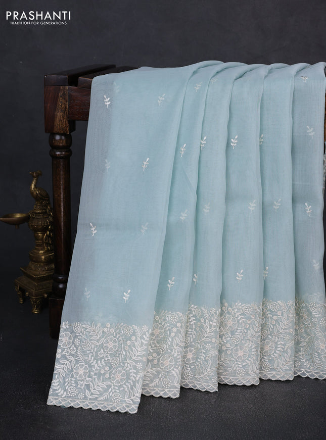 Organza saree teal blue with embroidery buttas and embroidery border