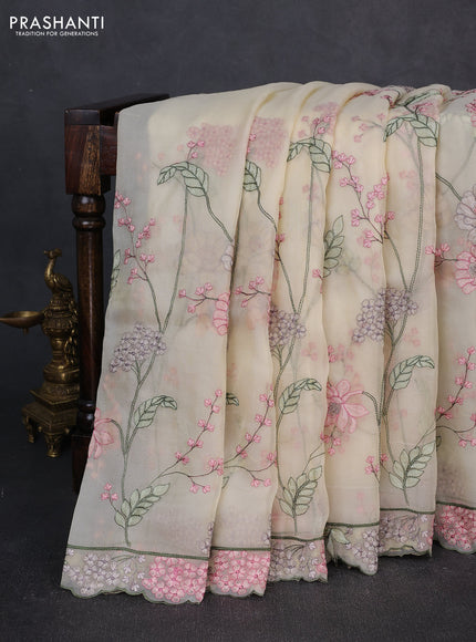 Tissue organza saree cream with allover floral embroidery and embroidery border