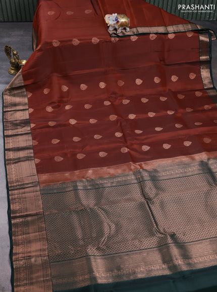 Kanchipuram silk saree rust shade and bottle green with copper zari woven buttas and copper zari woven border