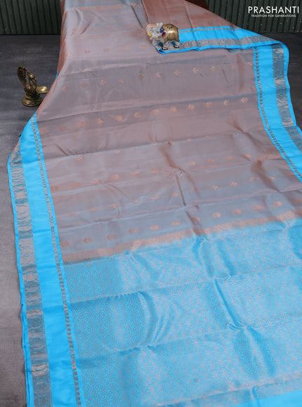 Kanchipuram silk saree dual shade of rust and light blue with copper zari woven buttas and rettapet copper zari woven border