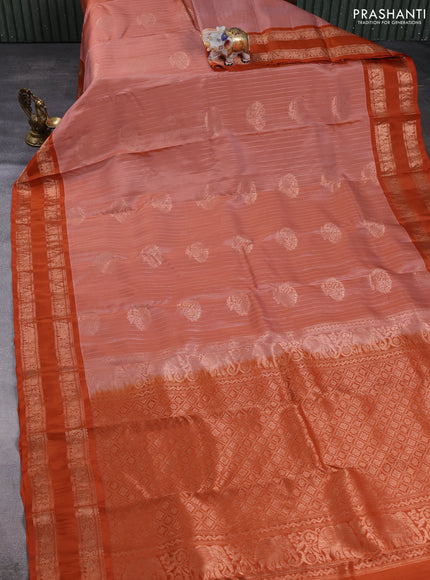 Kanchipuram silk saree pastel pink and rust shade with allover zari weaves & buttas and rettapet copper zari woven border