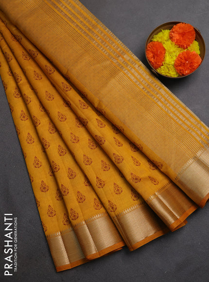 Semi raw silk saree dark mustard with allover butta prints and zari woven border