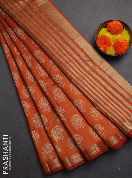 Semi raw silk saree rustic orange with allover floral butta prints and zari woven border