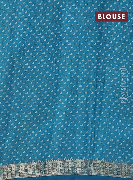Semi raw silk saree teal blue with allover floral butta prints and zari woven border