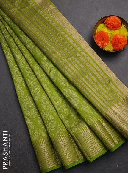 Semi raw silk saree light green with allover geometric butta prints and temple design zari woven border