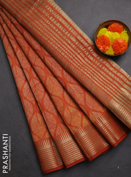 Semi raw silk saree rustic orange with allover geometric butta prints and temple design zari woven border