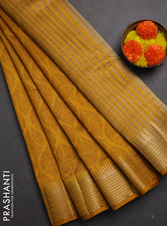 Semi raw silk saree dark mustard shade with allover geometric butta prints and temple design zari woven border