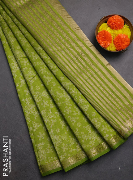 Semi raw silk saree light green with allover geometric prints and zari woven border