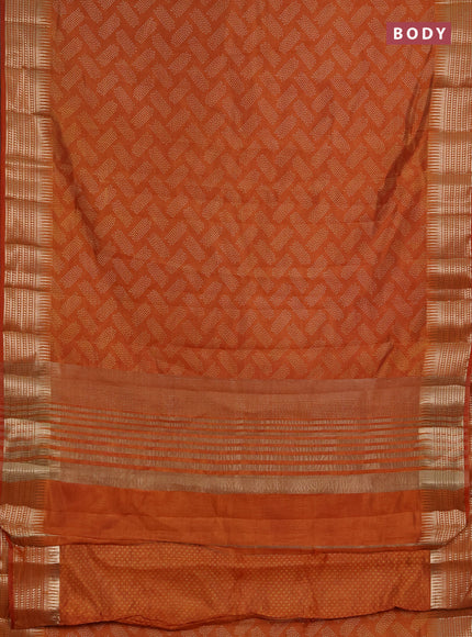 Semi raw silk saree rust with allover geometric butta prints and temple design zari woven border