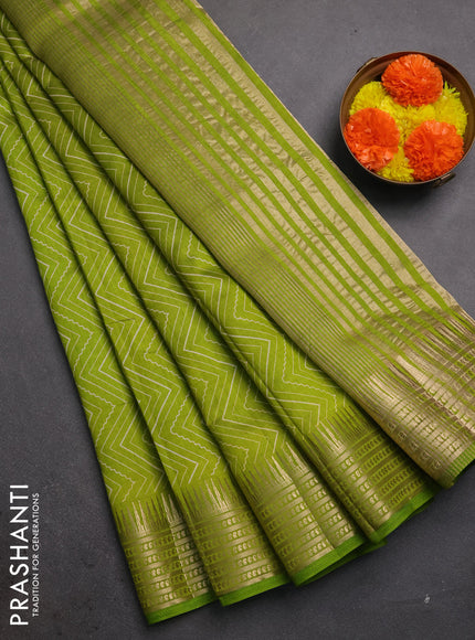 Semi raw silk saree light green with allover zigzag prints and temple design zari woven border
