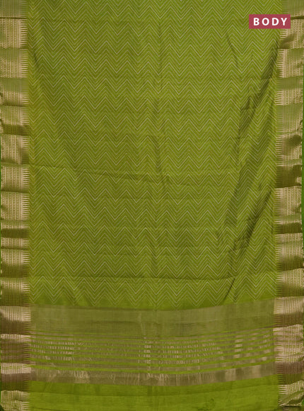 Semi raw silk saree light green with allover zigzag prints and temple design zari woven border