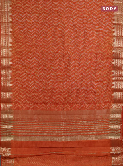Semi raw silk saree rustic orange with allover zigzag prints and temple design zari woven border