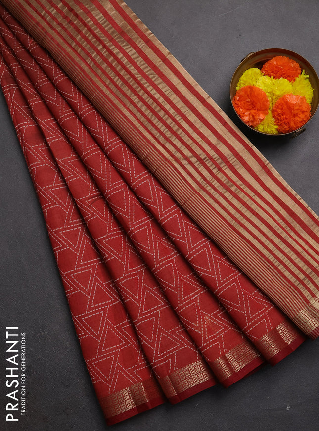 Semi raw silk saree rust shade with allover geometric prints and zari woven border