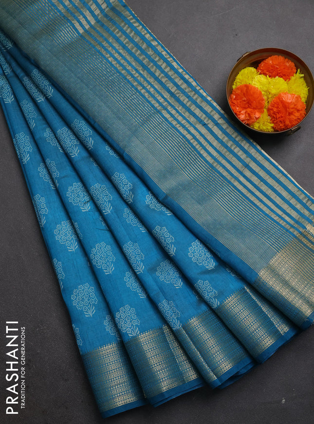 Semi raw silk saree teal blue with allover floral butta prints and zari woven border