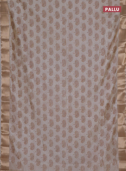 Semi raw silk saree cream with allover butta prints and zari woven border