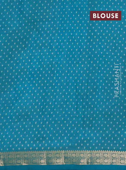 Semi raw silk saree teal green with allover butta prints and zari woven border