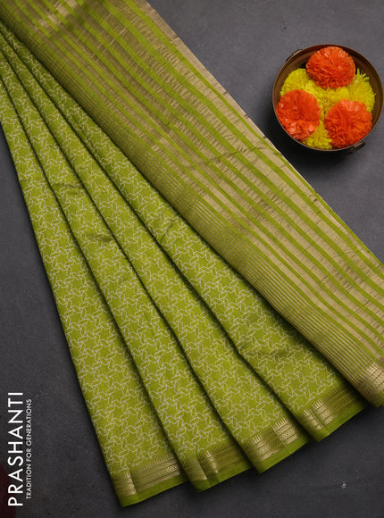 Semi raw silk saree light green with allover geometric prints and zari woven border