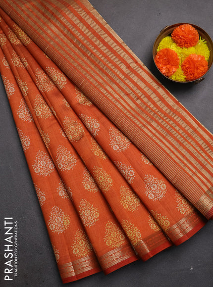 Semi raw silk saree rustic orange with allover floral butta prints and small zari woven border