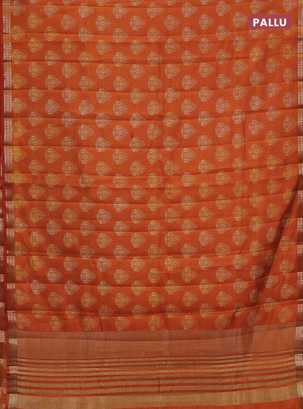 Semi raw silk saree rustic orange with allover floral butta prints and small zari woven border