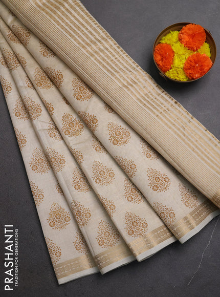 Semi raw silk saree cream with allover floral butta prints and small zari woven border