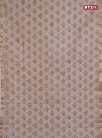 Semi raw silk saree cream with allover floral butta prints and small zari woven border