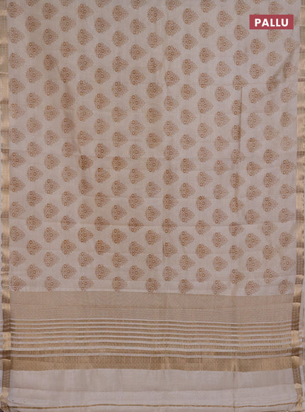 Semi raw silk saree cream with allover floral butta prints and small zari woven border
