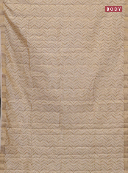 Semi raw silk saree cream with allover zigzag prints and zari woven border