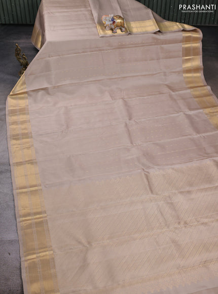 Pure soft silk saree beige and magenta pink with allover zari woven buttas and zari woven border