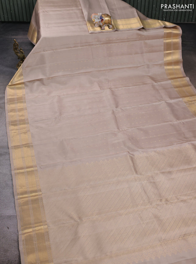 Pure soft silk saree beige and magenta pink with allover zari woven buttas and zari woven border