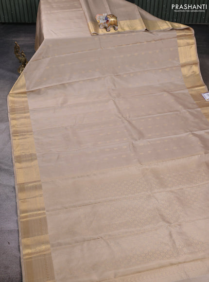 Pure soft silk saree beige and teal green with allover zari woven buttas and zari woven border
