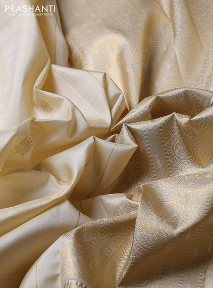 Puer kanchipuram silk saree cream with allover zari woven buttas and long zari woven border