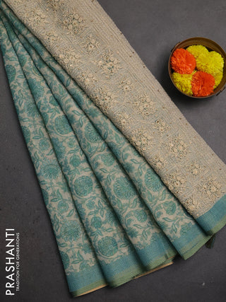 Linen saree beige and teal blue with allover floral prints and embroidery pallu