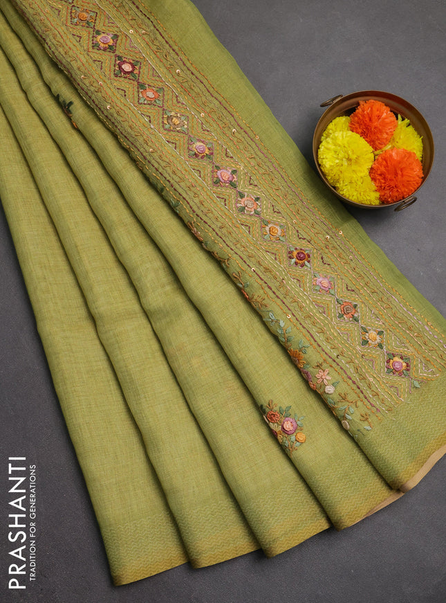 Linen saree light green with embroidery buttas and embroidery pallu