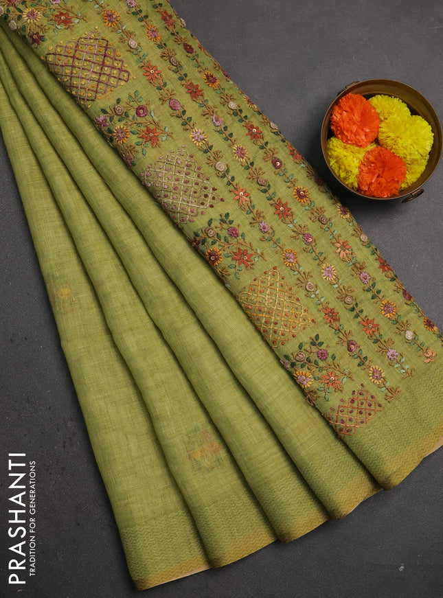Linen saree light green with embroidery buttas and embroidery pallu