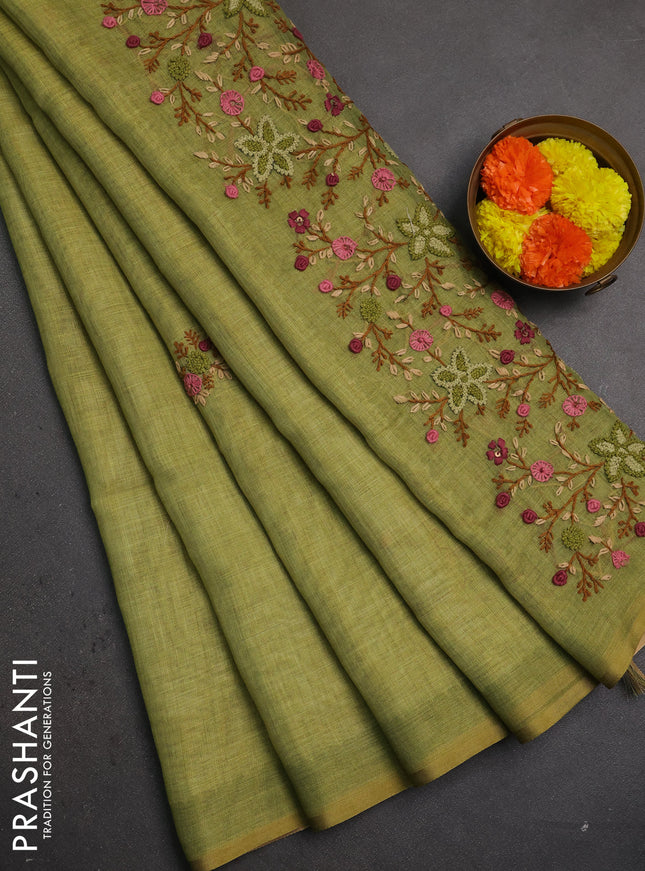 Linen saree light green with embroidery buttas and embroidery pallu