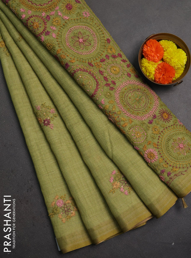 Linen saree light green with embroidery buttas and embroidery pallu