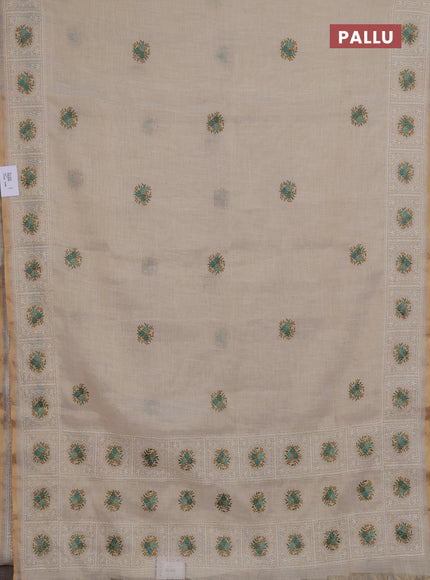 Linen saree beige and teal green with embroidery buttas and embroidery pallu